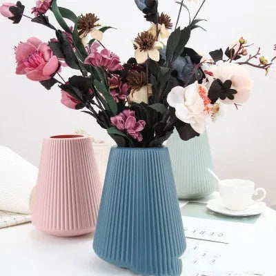 Colourful melamine plastic decorative flower vase measuring 16cm by 20cm on a desktop.