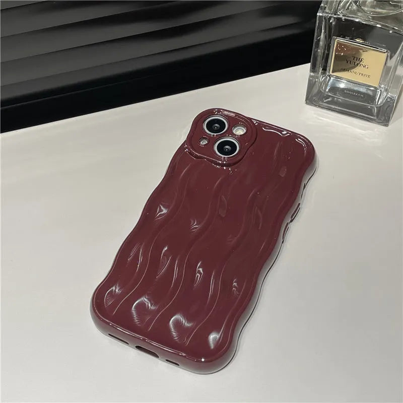 Silicone iPhone case with water ripple texture in green, shown on an iPhone 17 model