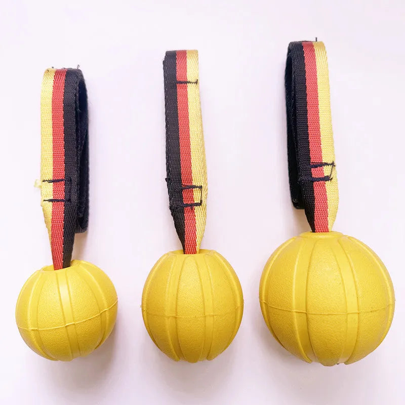 Floating camouflage and yellow EVA pet training ball with knotted tether in three diameter sizes for water retrieval