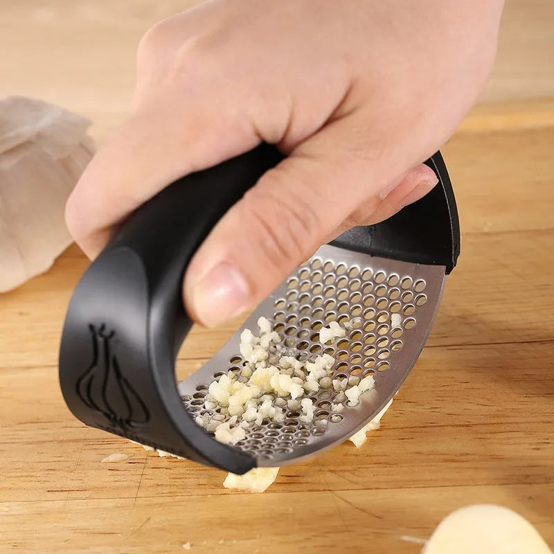 304 stainless steel garlic press in black, blue, green, and pink colour options on a kitchen counter