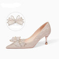 Women's champagne gold stiletto high heels covered in crystal sequins with a pointed toe.