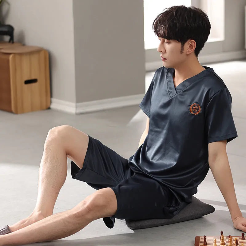 Man's ice silk short-sleeve pyjama shirt and shorts set in a loose, comfortable fit on a hanger