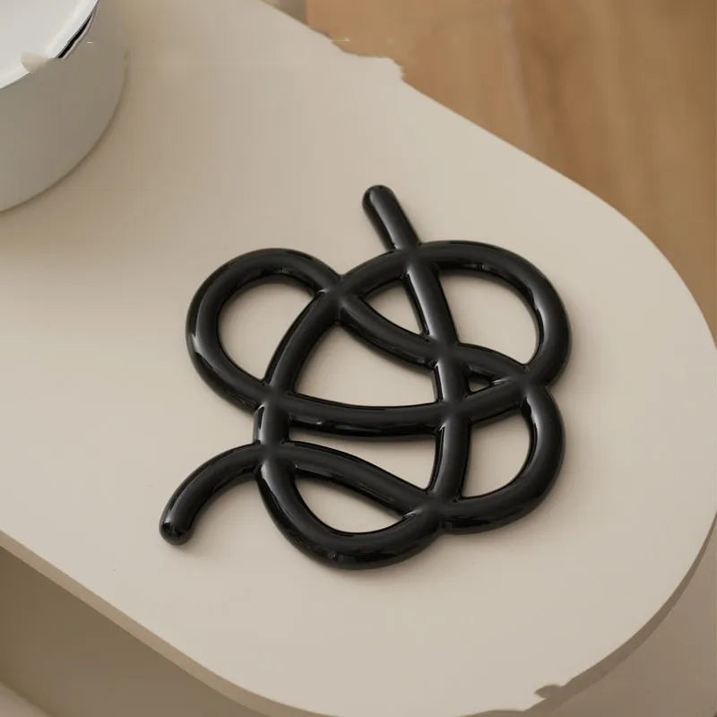 Ceramic heat proof mat in irregular shape on dining table surface