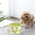 Green robot-shaped elevated cat bowl with tilted dish and non-slip base