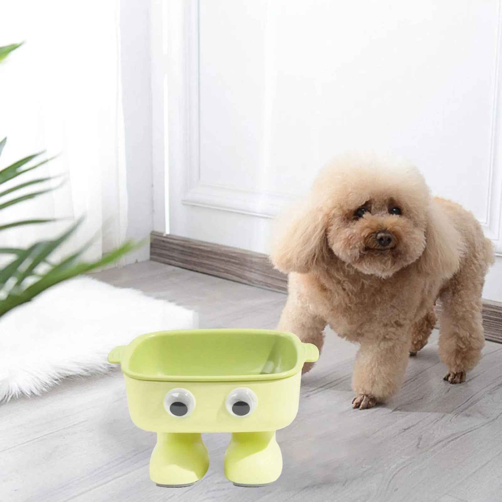 Green robot-shaped elevated cat bowl with tilted dish and non-slip base