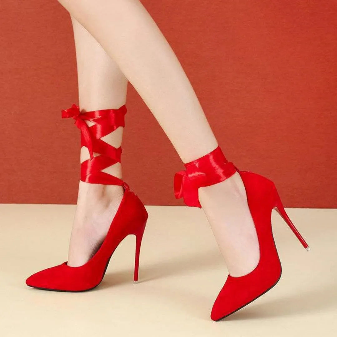 Black pointed toe stiletto shoe with shallow mouth design and a fabric strap with flat buckle