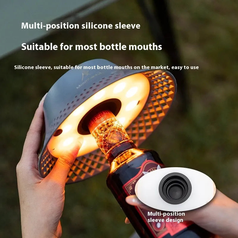 Beige wine bottle-shaped camping lantern showing three light mode settings and USB-C charging port.
