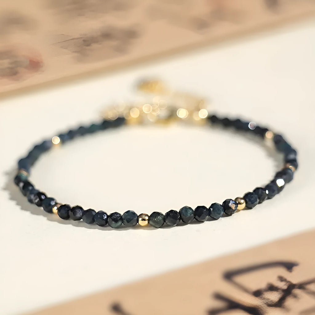 Blue tourmaline bracelet with 3mm beads and spacer bead design on wrist