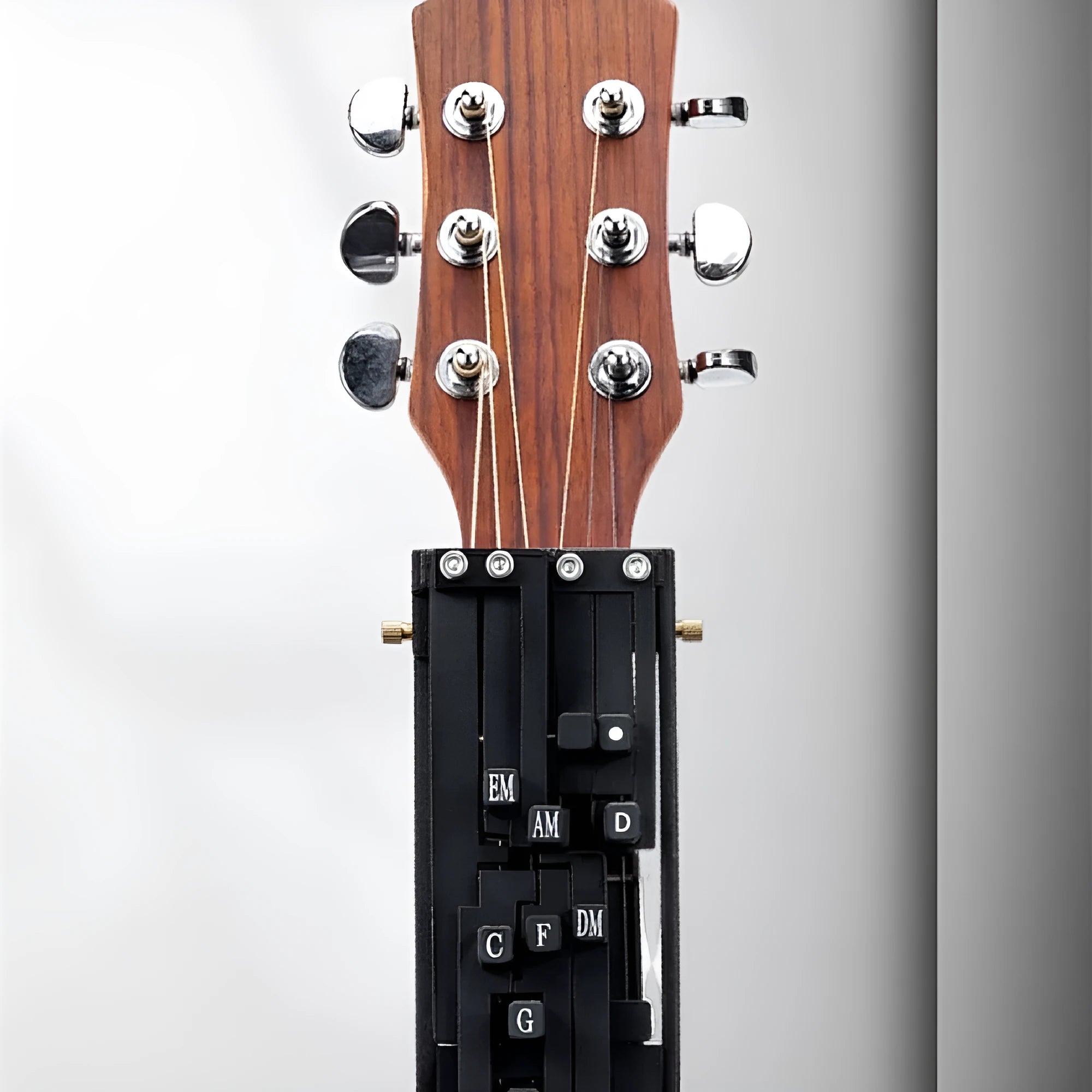 Black guitar capo with second chord feature for beginner folk guitar practice