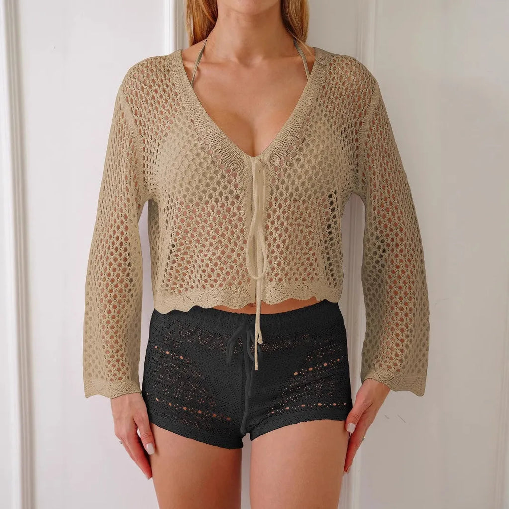 Short women's cardigan blouse with bell sleeves in a hollow woven cotton-like fabric.