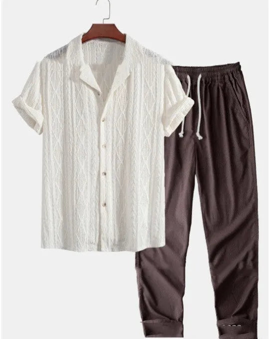 Man wearing a loose-fit light blue short sleeve shirt and matching trousers from a milk silk summer suit.