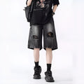 Loose fit ripped denim shorts in black and blue washes on a size chart