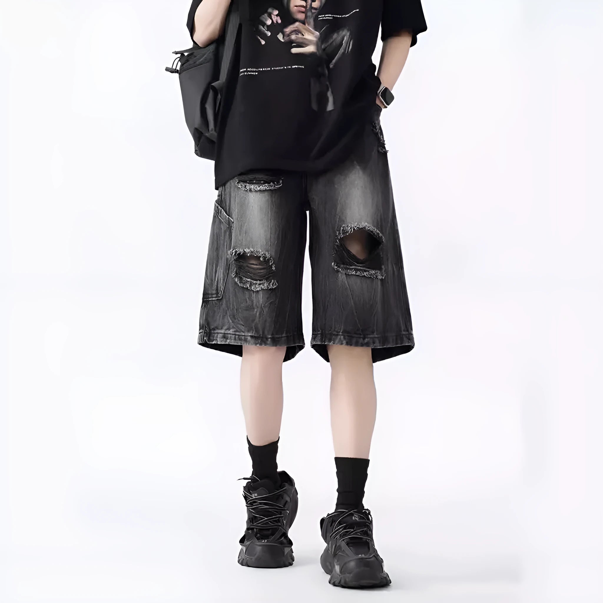 Loose fit ripped denim shorts in black and blue washes on a size chart