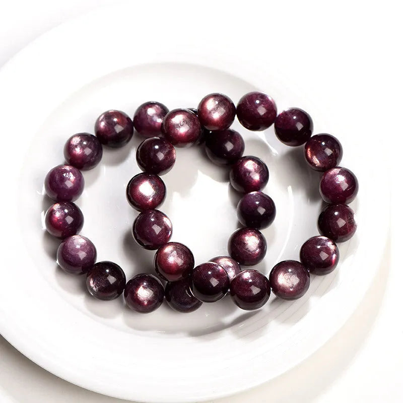 Natural purple lepidolite crystal bracelet with round polished beads on a wrist.
