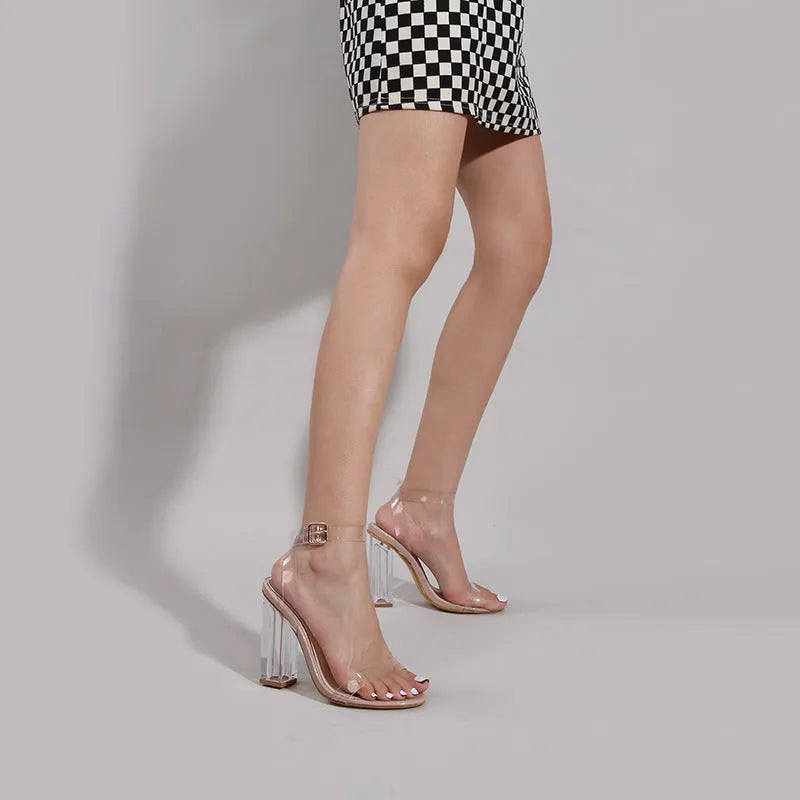 Apricot coloured women's high-heel sandals with a clear glass heel and a buckle fastening.