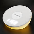 White wireless phone charger with digital clock display, three control buttons, and LED night light