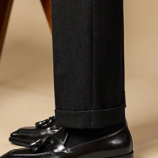 Men's black and brown tassel loafers with polished leather uppers and rubber soles