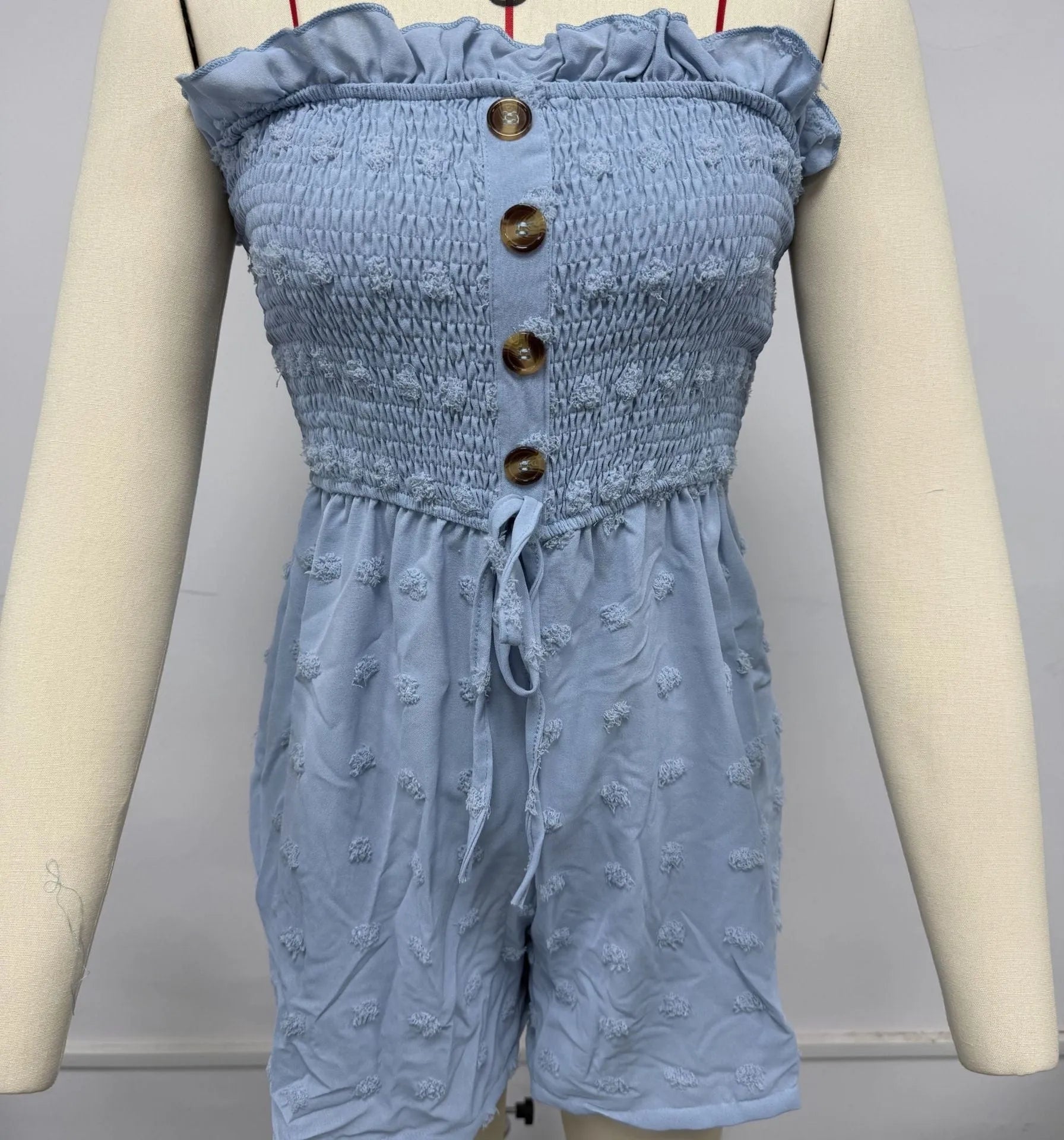 Blue sleeveless off-shoulder women's jumpsuit with button detail and mid waist fit