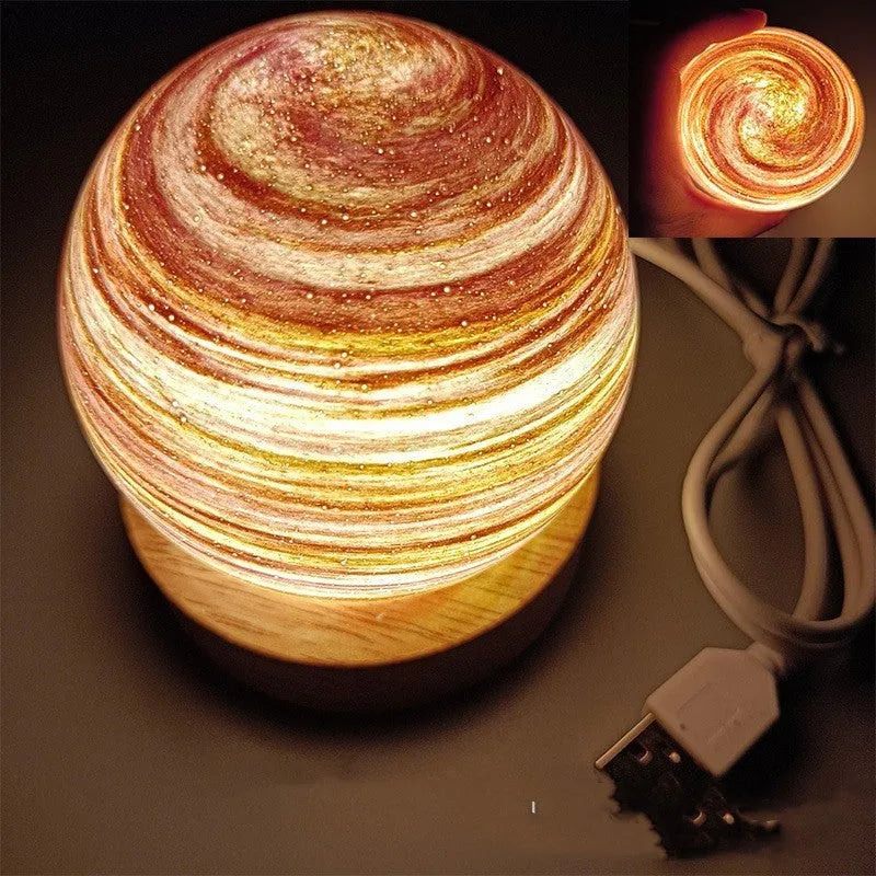 Compact modern planet USB night light on its base with dimmable three-colour lighting.
