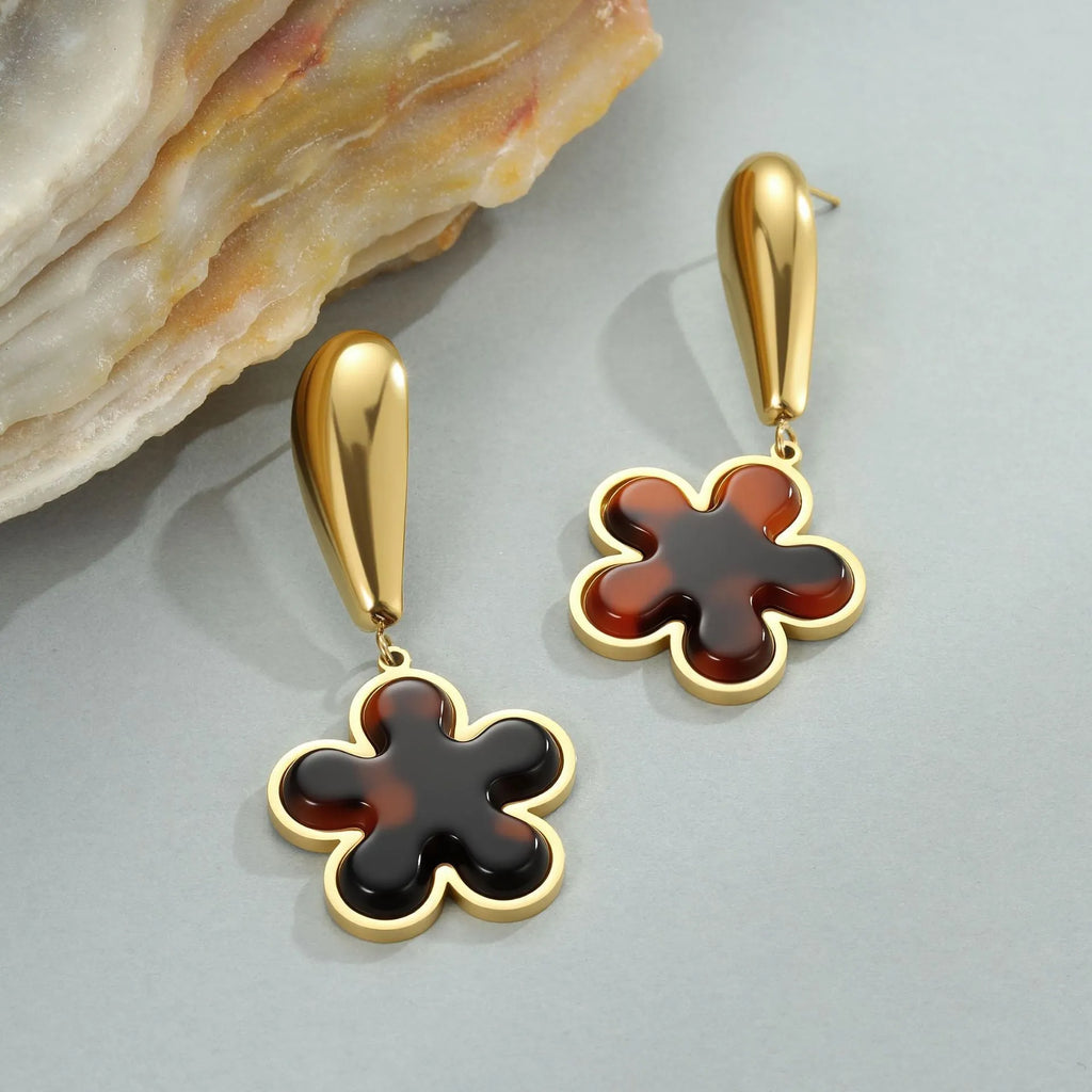 Gold electroplated tortoiseshell resin earrings in heart and geometric floral designs for women.