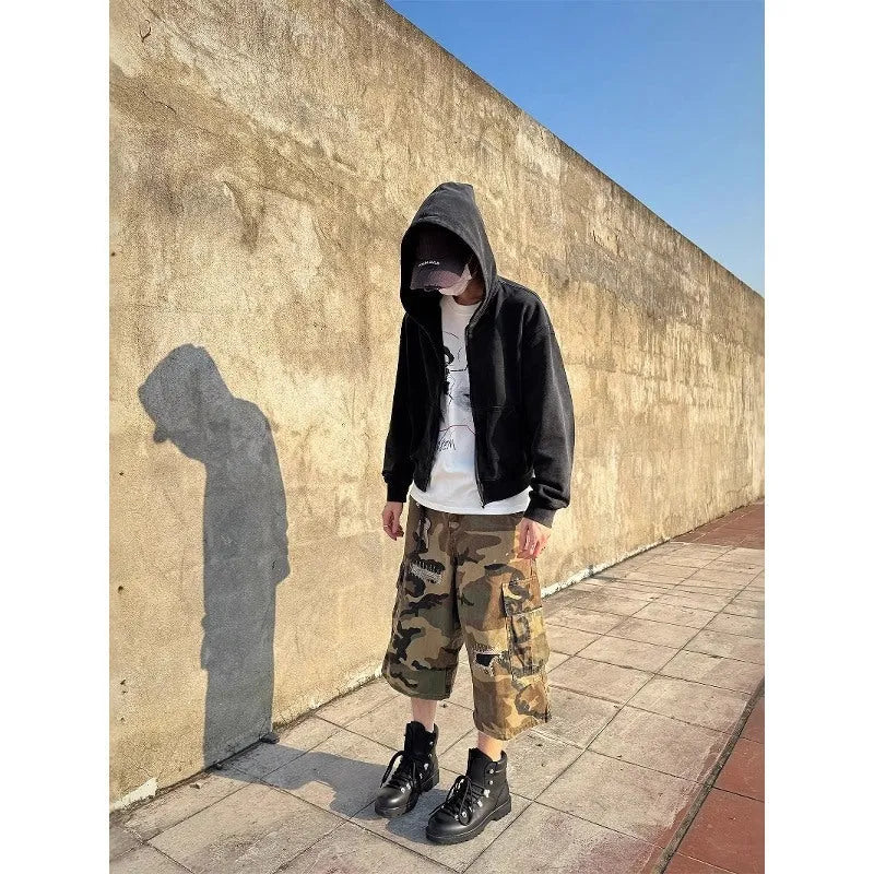 Men's camouflage cropped jeans with retro patches and ripped detailing on loose straight-leg trousers