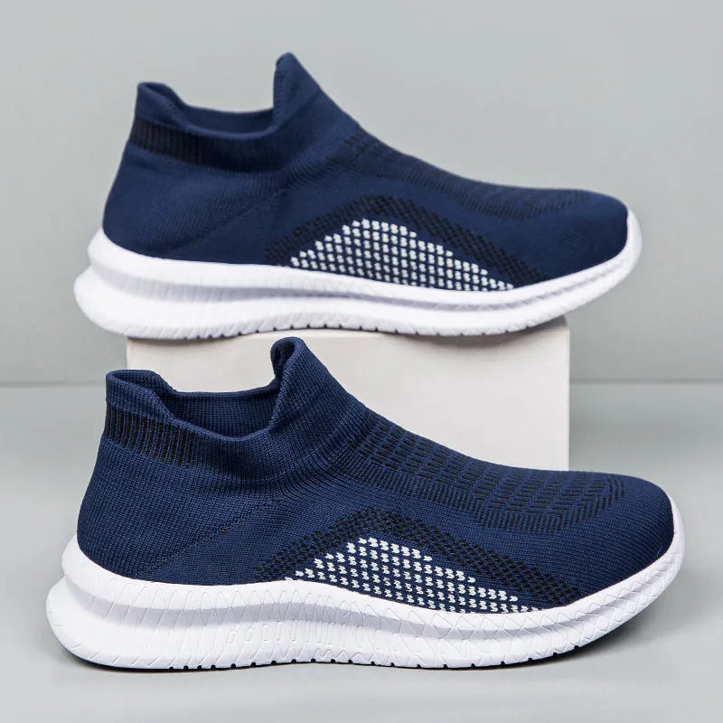 Popcorn Flyknit low top casual sneakers in white, black, and blue colours on a plain background.