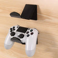 A universal plastic wall mount bracket for game controllers, shown in black, white, and transparent colour options.