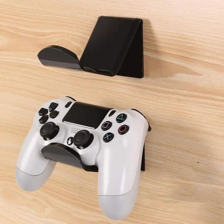 A universal plastic wall mount bracket for game controllers, shown in black, white, and transparent colour options.