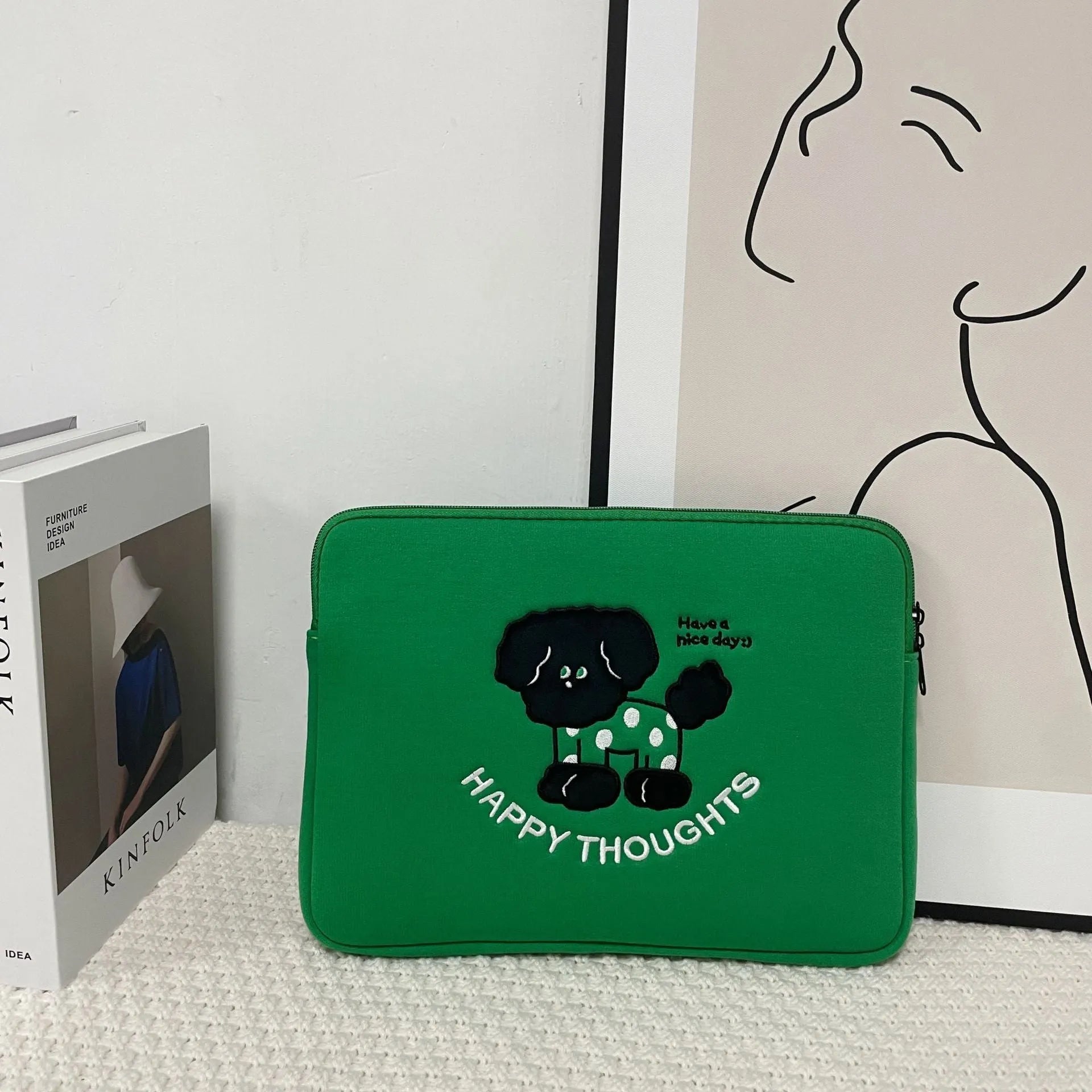 Embroidered animal design laptop liner bag in polyester fabric.