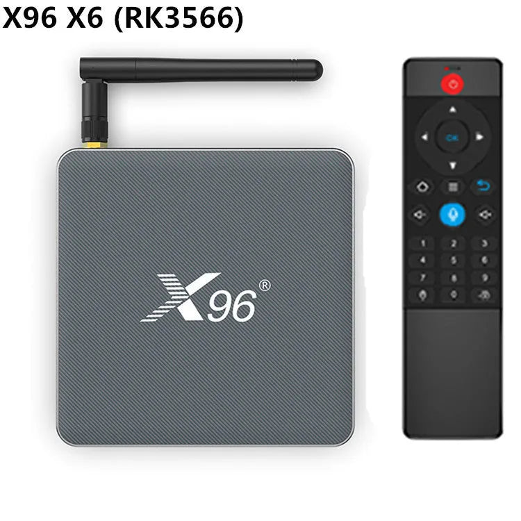 Android smart TV set-top box with voice remote control, HDMI cable, and power adapter on a table.