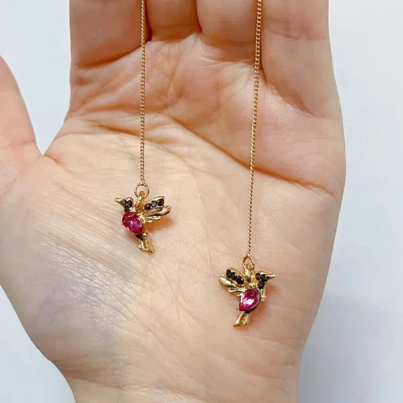 Long drop bird shaped alloy earrings for women with zirconium wings, shown in blue, red, and red lvzuan colour variations.