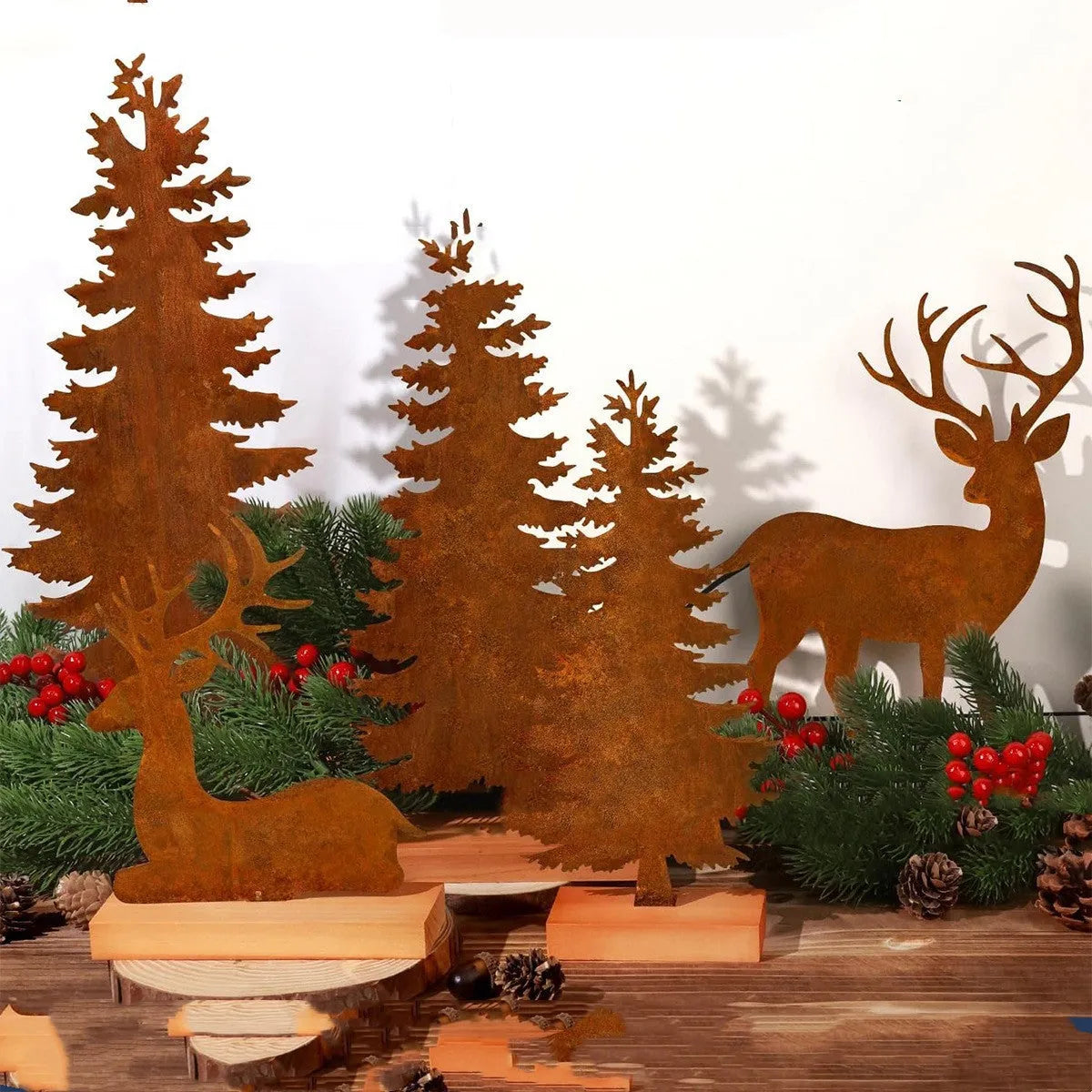 Three metal Christmas tree ornaments with elk motifs in rustic patina finish