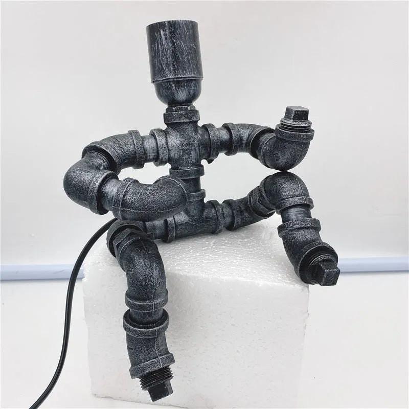 Industrial vintage table lamp constructed from iron water piping in a retro colour