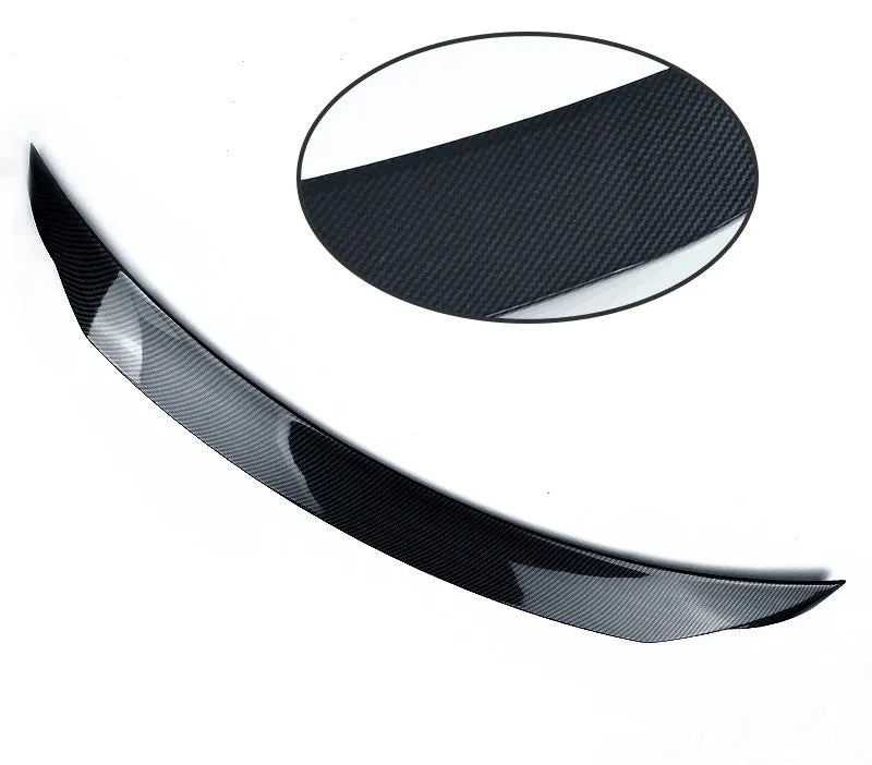 Mazda 3 Axela Exela rear diffuser spoiler tail trim in bright black installed on car bumper.