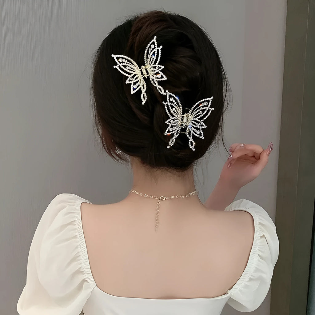 Elegant butterfly-shaped alloy hair clip for women, shown in rhinestone and pearl style options.