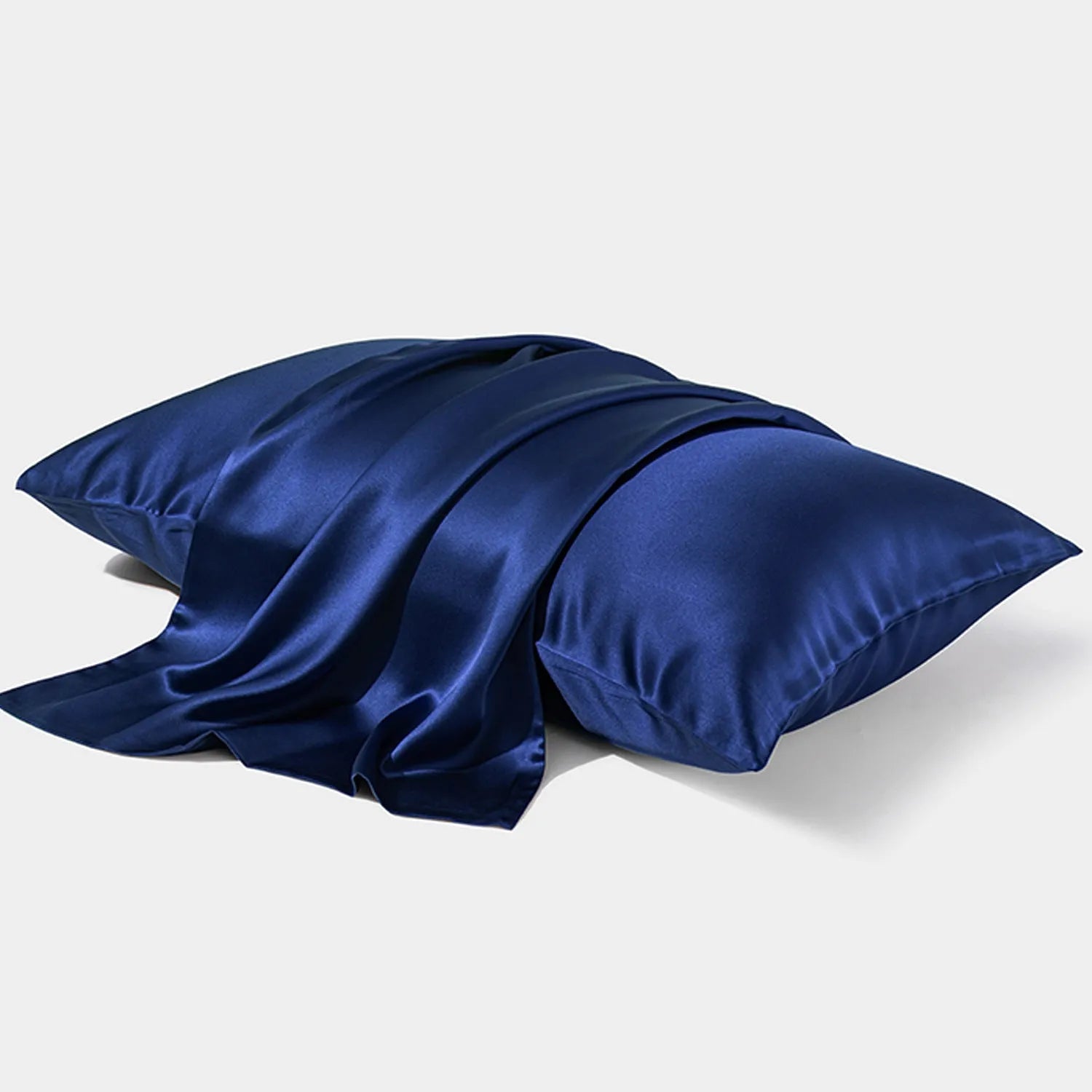 Dark grey mulberry silk pillowcase with an envelope closure on a bed.