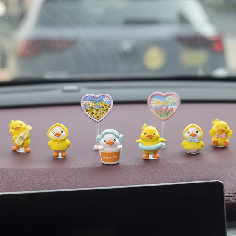 PVC cartoon duckling car decoration set with six small ducks and one Hello sign on a dashboard.