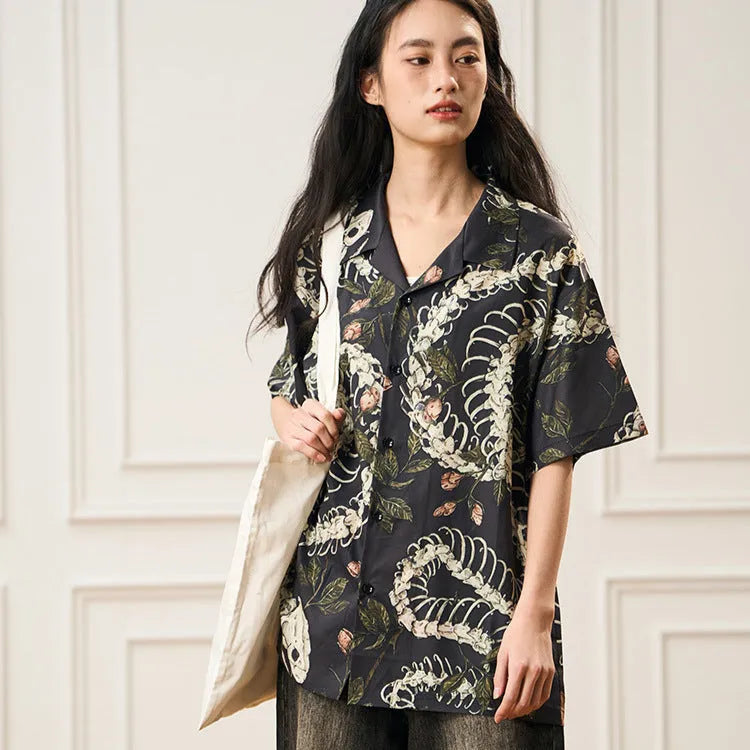 Short sleeve loose fit shirt with snake bone and floral pattern print and a Cuban collar.