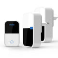 White plastic wireless doorbell receiver and self-generating button on a white background.