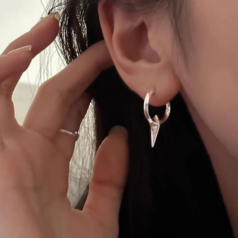 Women's geometric star-shaped ear clip with an electroplated platinum or white gold finish.