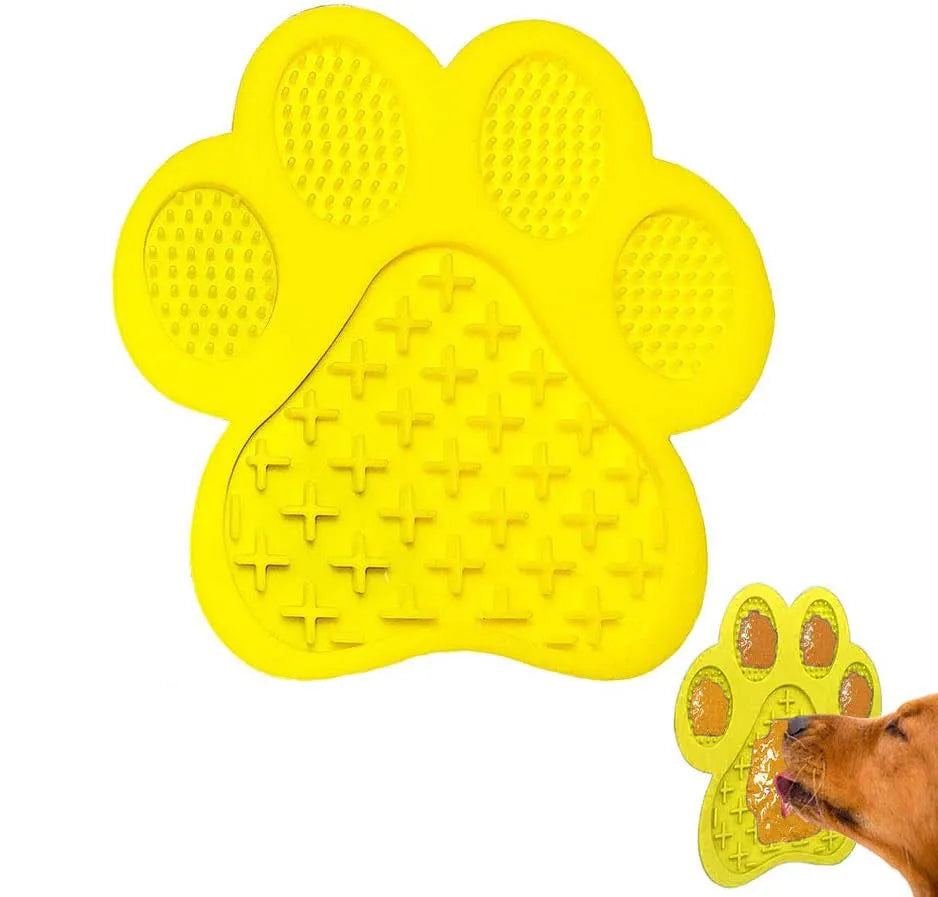 Blue silicone dog licking mat with bone texture and suction cups on a white bathroom tile.