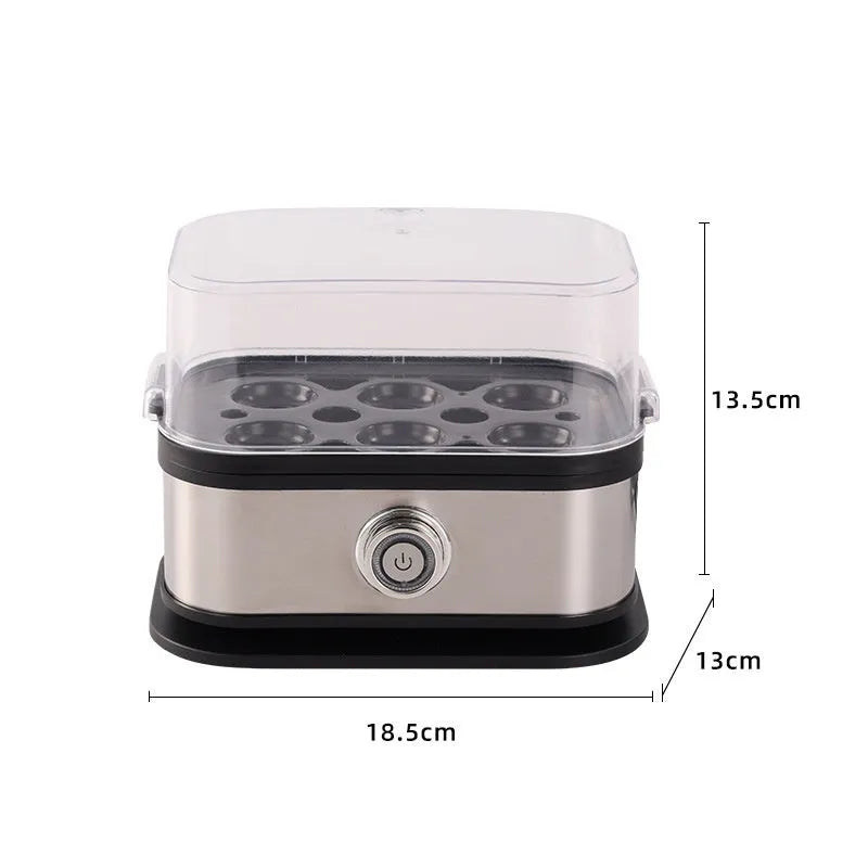 Small black stainless steel portable egg boiler with plug adapters on a countertop.