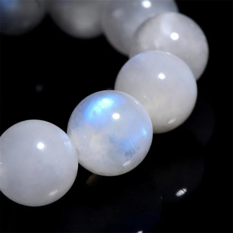 Natural blue moonlight round bead moonstone bracelet showing polished stone beads on wrist