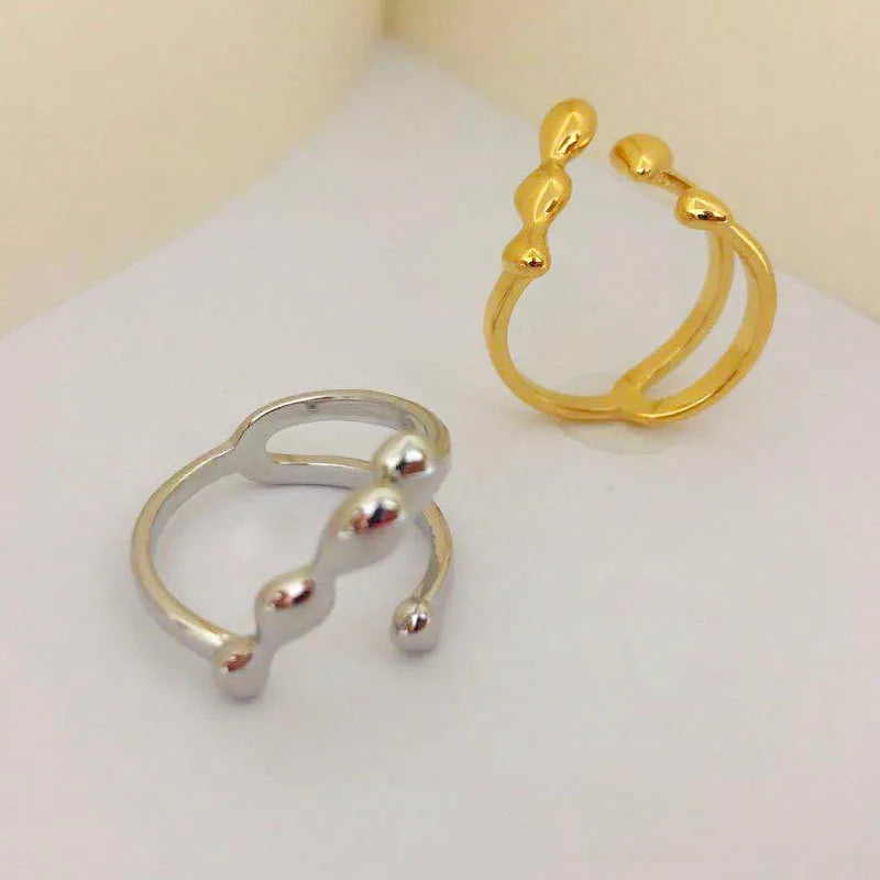 Women's brass opening ring with gold finish and circle sphere design