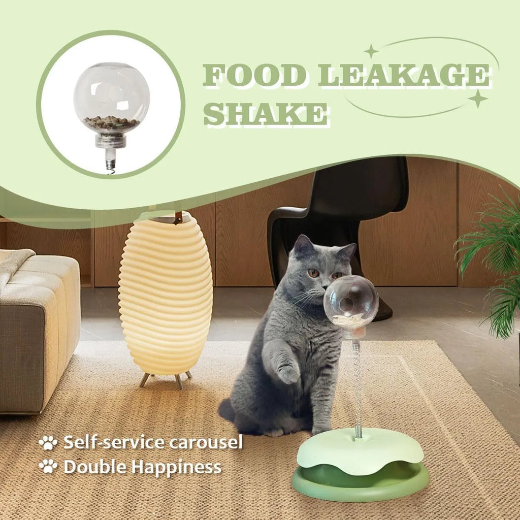 Blue and green cat treat dispenser toy with track ball on a wooden floor