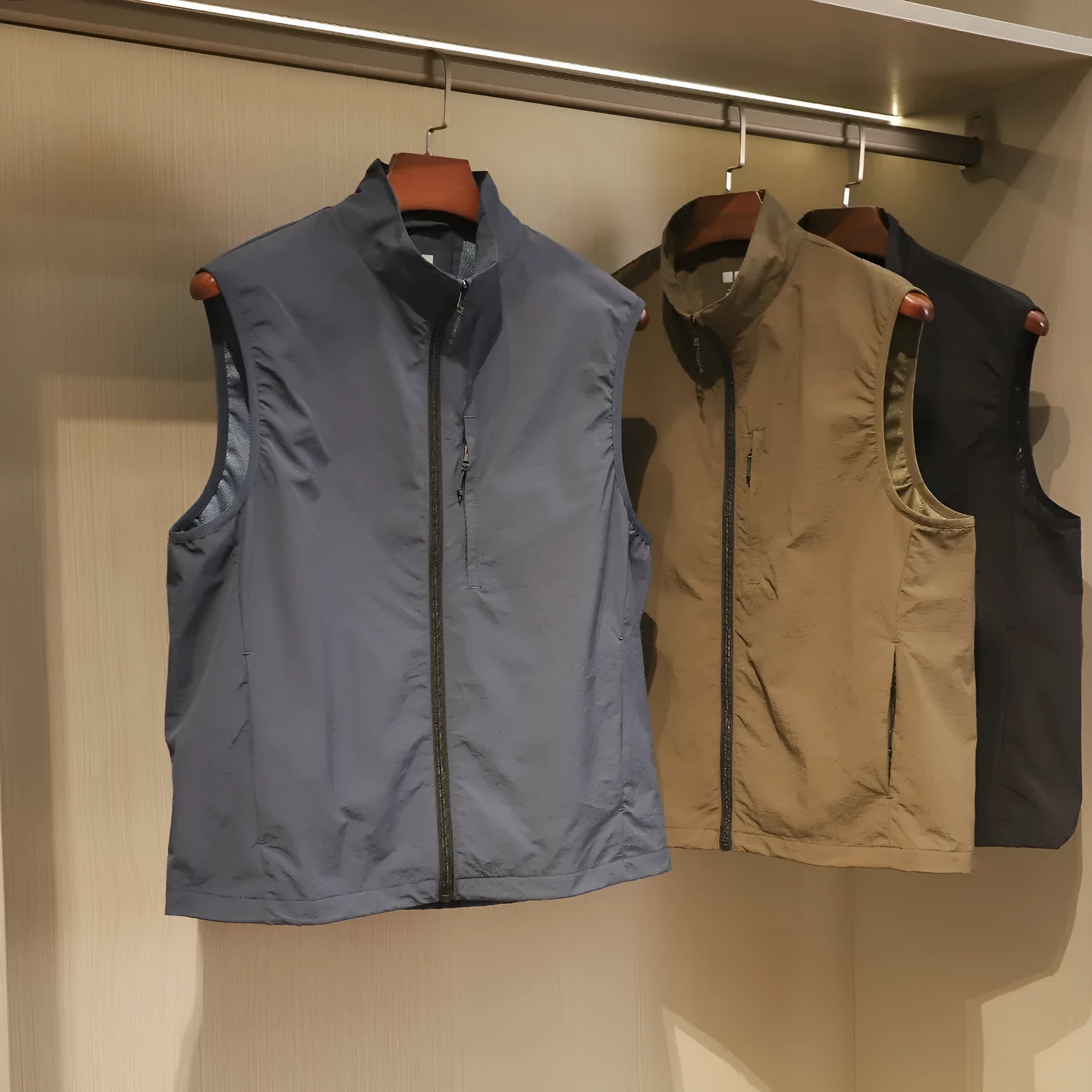 Men's straight cut nylon vest in army green with side seam pockets.