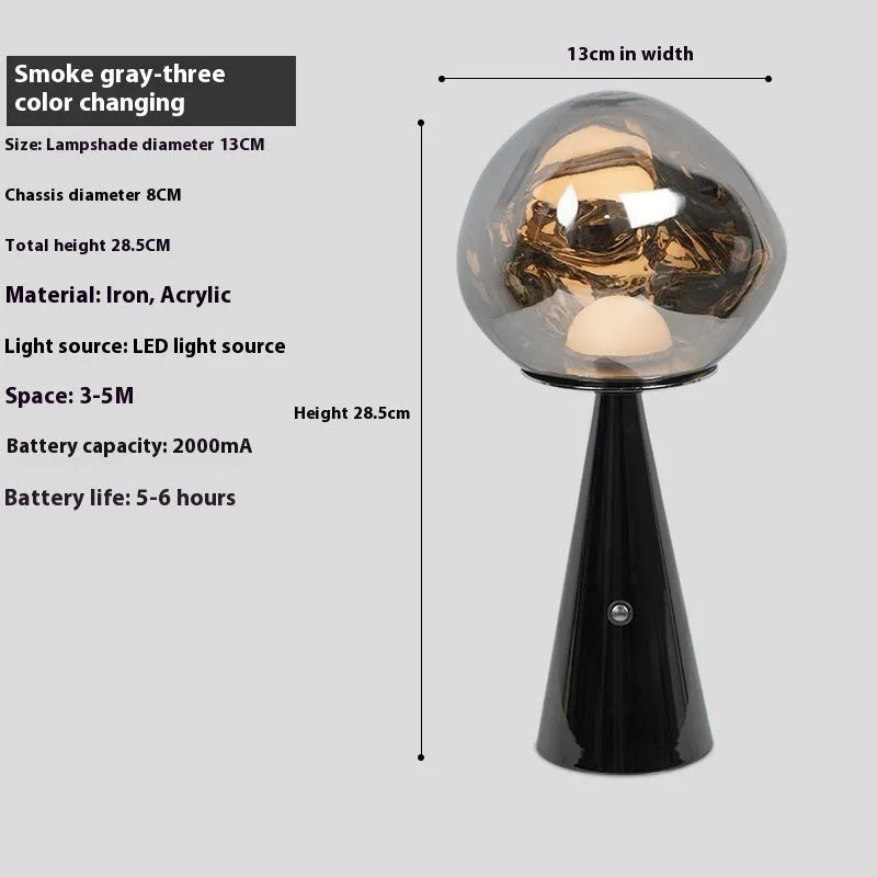 Volcanic lava mini table lamp with metal holder in gold finish, USB magnetic charging, on a bedside table