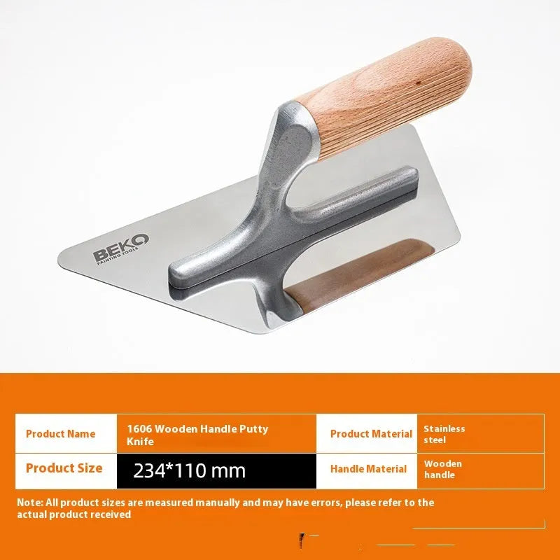 Three stainless steel putty scraper tools with wooden handles in different sizes on a workbench.