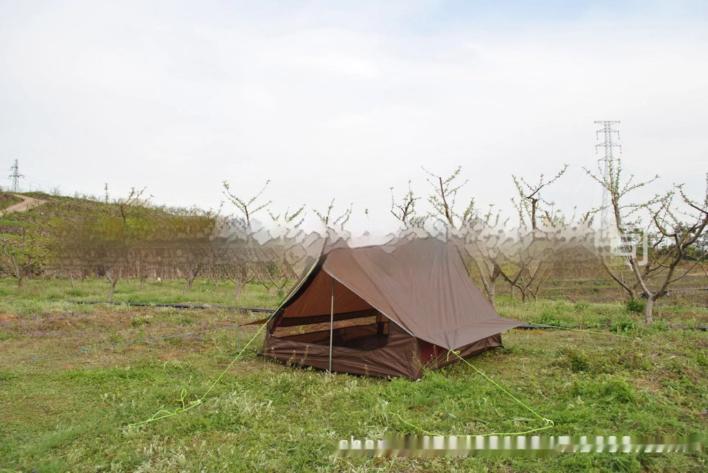 Brown or white A-line cabin tent pitched with trekking poles, showing spacious interior and waterproof fabric construction