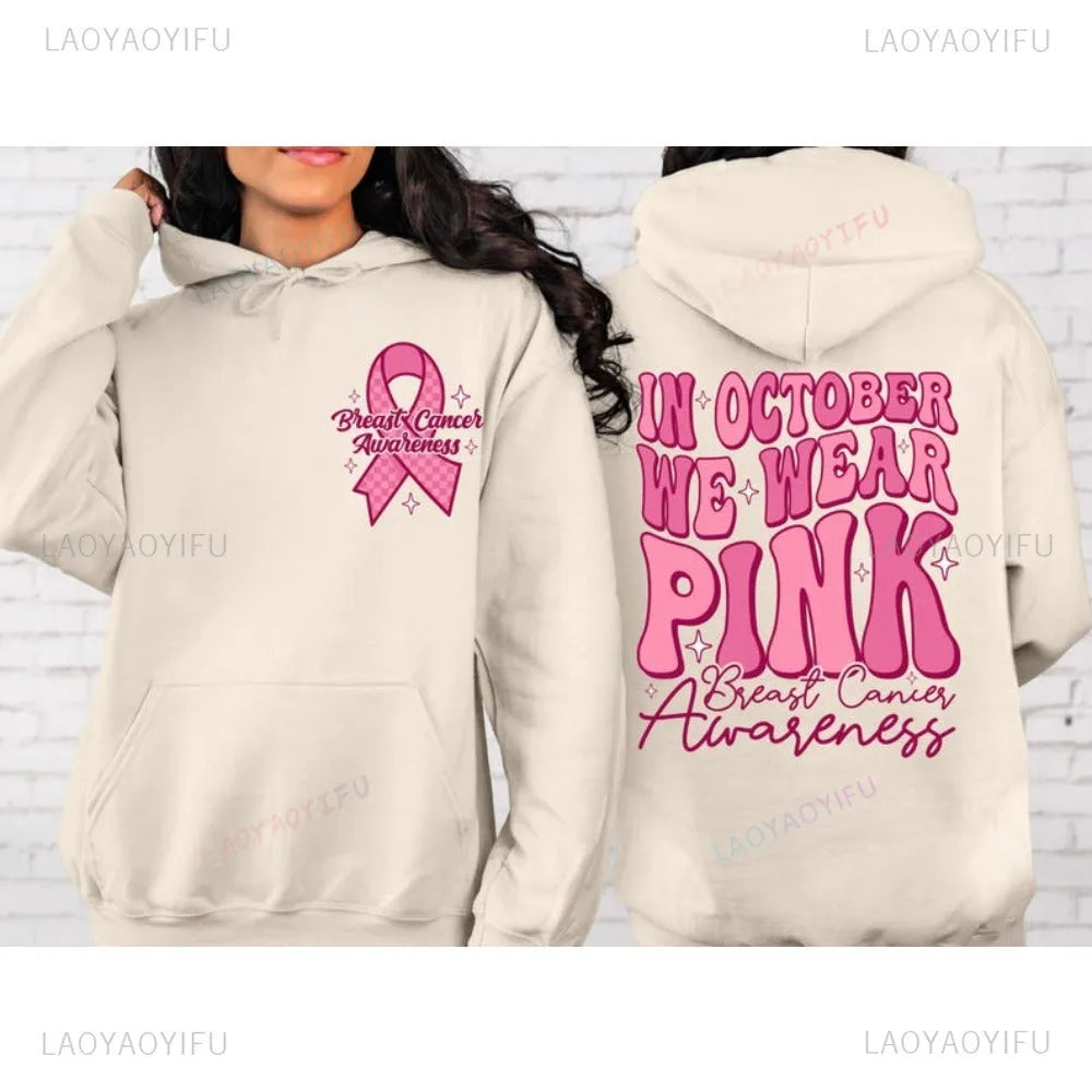 Pink pullover hoodie with a breast cancer awareness slogan, retro graphic, and side seam pockets.
